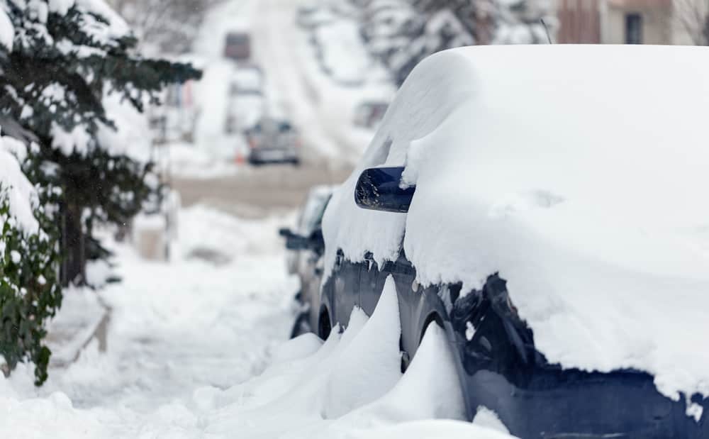 Snow Buried Car Parked on Side of Road